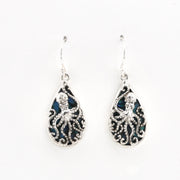 A pair of silver teardrop dangle earrings featuring an intricate octopus filigree design over a dark blue iridescent inlay, shown on a plain white background.