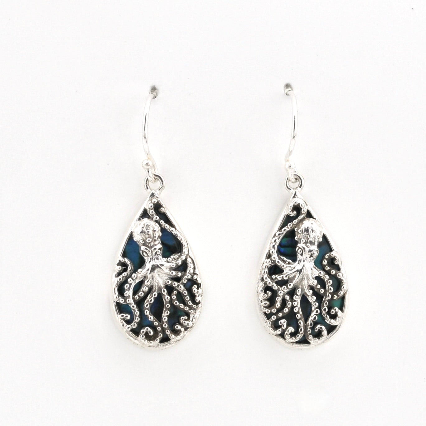 A pair of silver teardrop dangle earrings featuring an intricate octopus filigree design over a dark blue iridescent inlay, shown on a plain white background.
