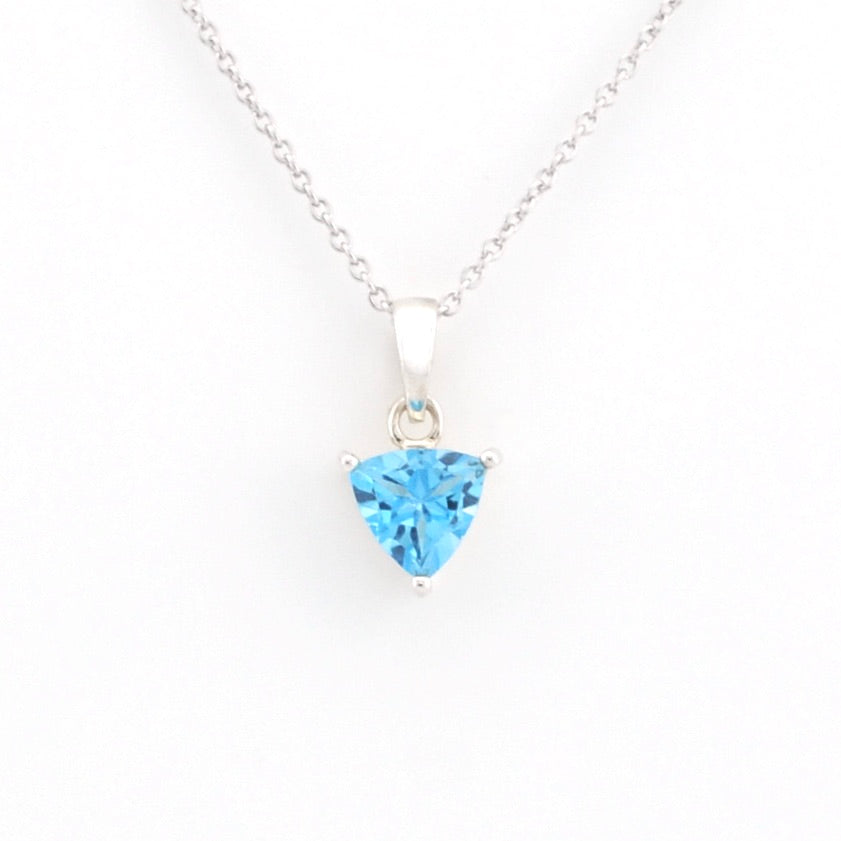 A silver necklace with a trillion-shaped light blue gemstone pendant, displayed against a clean white background.