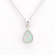 A silver teardrop pendant necklace featuring a white opal stone with subtle green and blue iridescence, displayed on a clean white background.