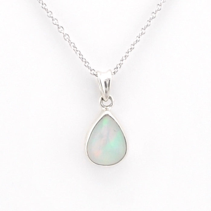 A silver teardrop pendant necklace featuring a white opal stone with subtle green and blue iridescence, displayed on a clean white background.