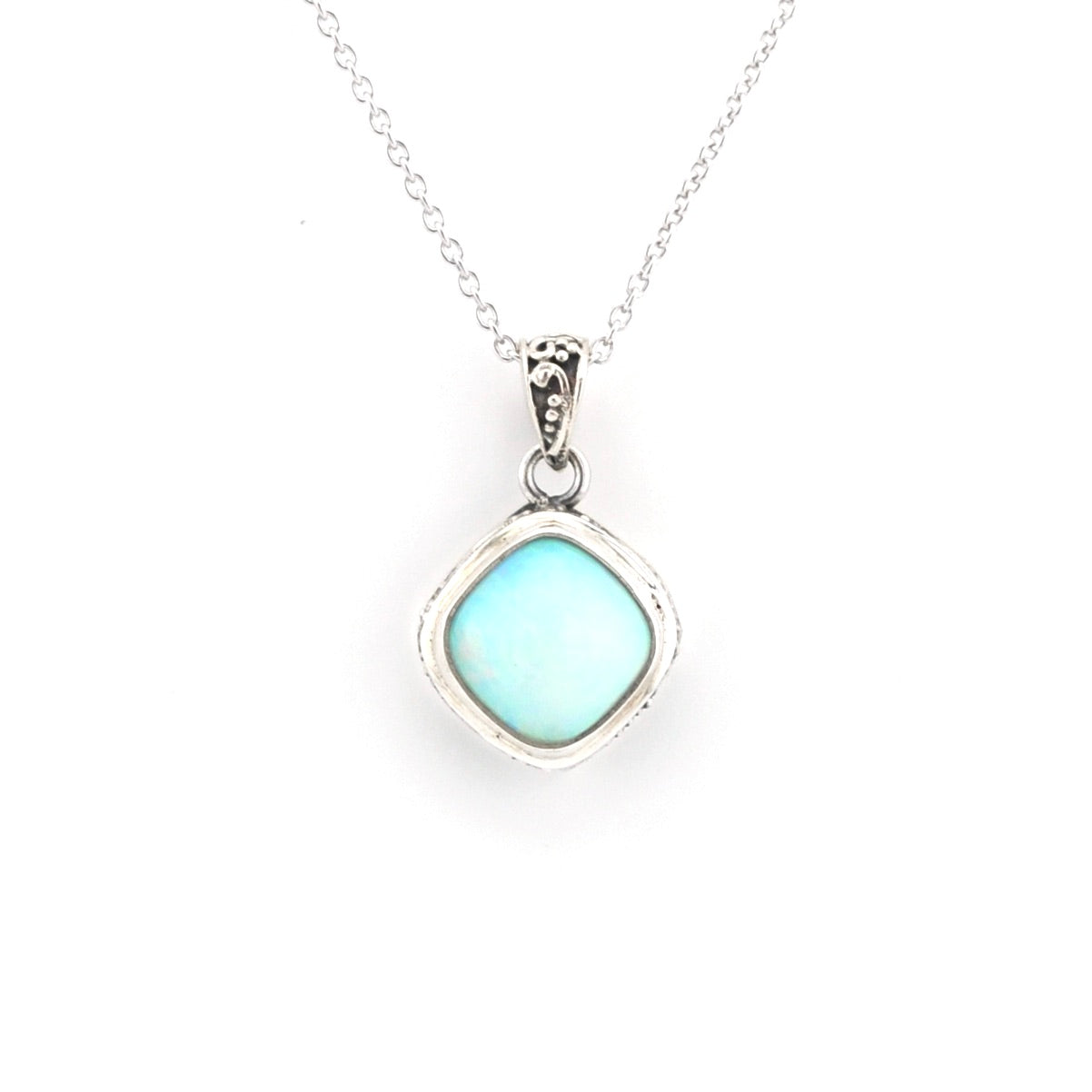 A silver pendant necklace featuring a square-shaped light blue opal stone in a silver bezel setting, suspended from a delicate silver chain against a plain white background.