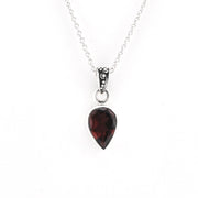 Garnet pendant on a silver chain on a white background.