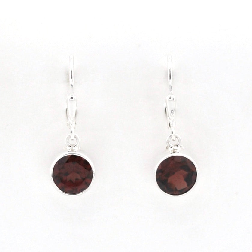 A pair of silver leverback drop earrings with round dark red garnet gemstones, shown against a plain white background.
