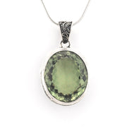 An oval-cut green gemstone pendant in a silver bezel setting on a silver chain, shown against a plain white background.