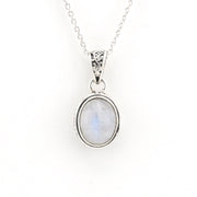 A silver pendant necklace featuring an oval-shaped light blue and white moonstone gemstone in a silver bezel setting, suspended from a delicate silver chain against a plain white background.