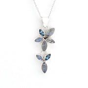 A silver pendant necklace featuring a floral design with marquise-cut blue-gray iridescent stones on a delicate silver chain, set against a plain white background.