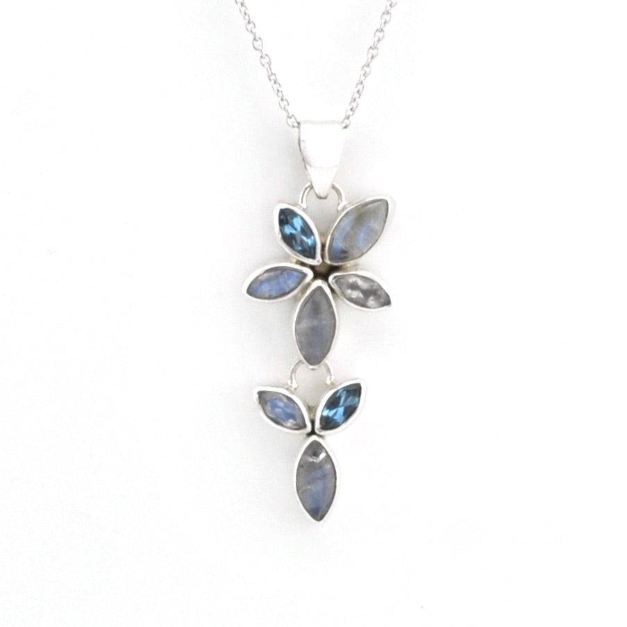 A silver pendant necklace featuring a floral design with marquise-cut blue-gray iridescent stones on a delicate silver chain, set against a plain white background.