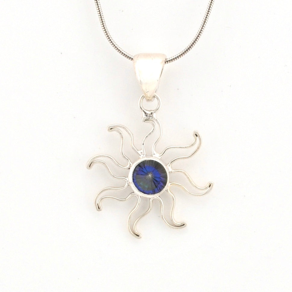 Silver sun-shaped pendant with a blue gemstone on a white background
