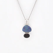 Opal and Garnet pendant with chain on white background.