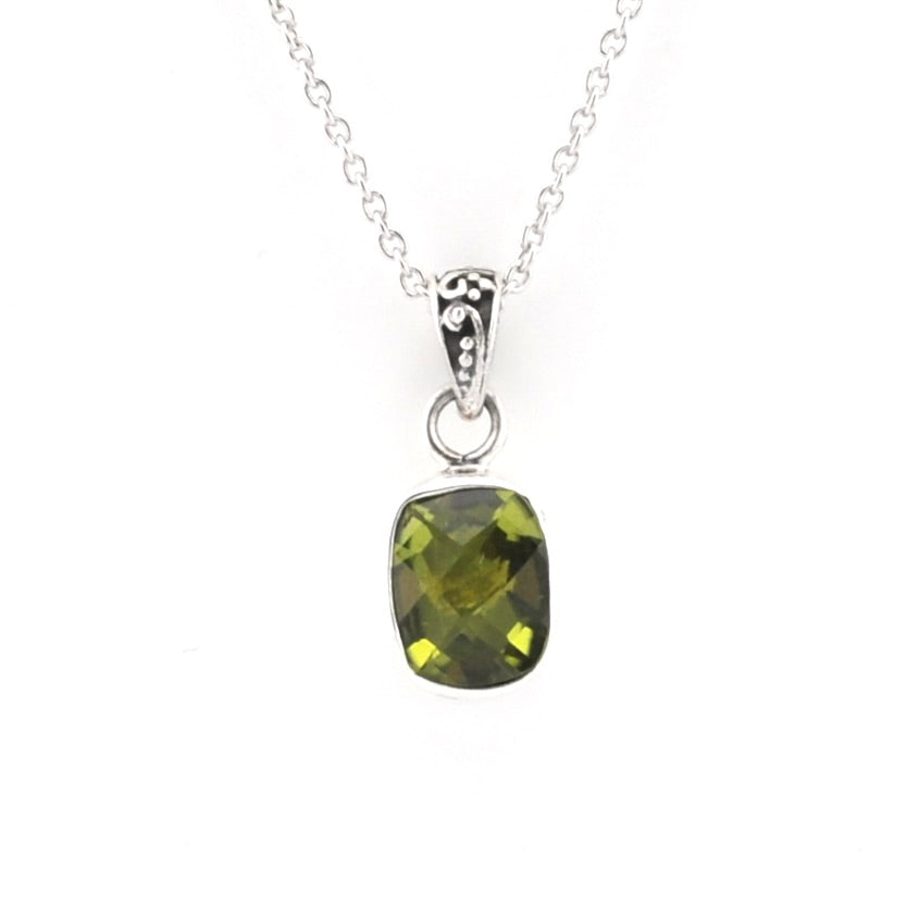 A silver pendant necklace featuring a cushion-cut olive green gemstone in a silver bezel setting, suspended from a delicate silver chain against a plain white background.
