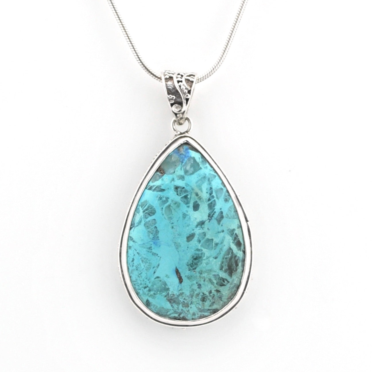 A teardrop-shaped turquoise pendant necklace in a silver bezel setting on a delicate silver chain, shown against a plain white background.