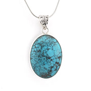 An oval turquoise pendant necklace with a silver-toned bezel and chain, displayed on a clean white background.