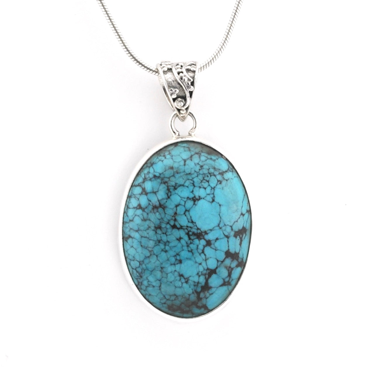 An oval turquoise pendant necklace with a silver-toned bezel and chain, displayed on a clean white background.