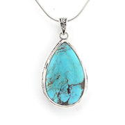 A teardrop-shaped turquoise pendant necklace with a silver bezel setting and a silver snake chain, shown against a plain white background.