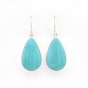 A pair of silver drop earrings featuring teardrop-shaped turquoise gemstones, displayed against a clean white background.