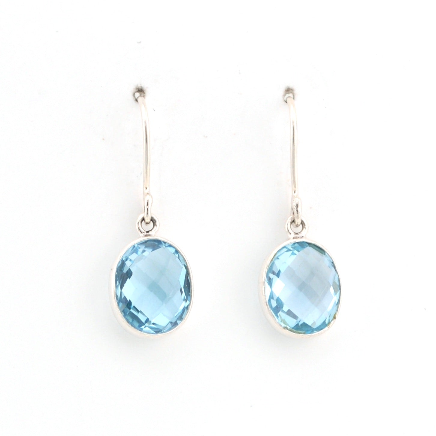 Pair of earrings with blue gemstones on a white background