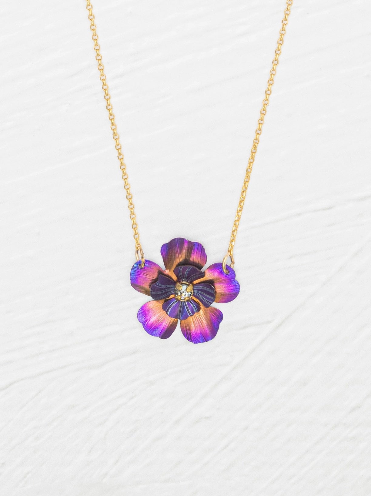 Necklace with a colorful flower pendant on a white background