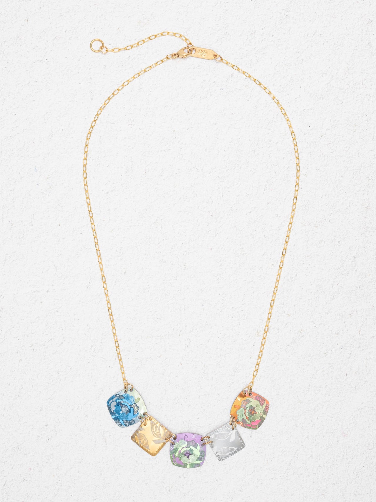 Necklace with colorful crystal pendants on a light gray background