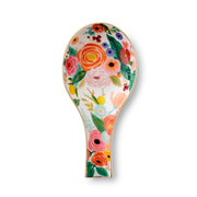 Decorative spoon rest with floral design on a white background