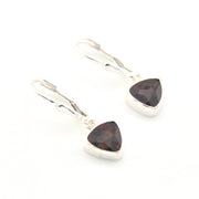 Pair of silver earrings with triangle-shaped garnet stones on a white background