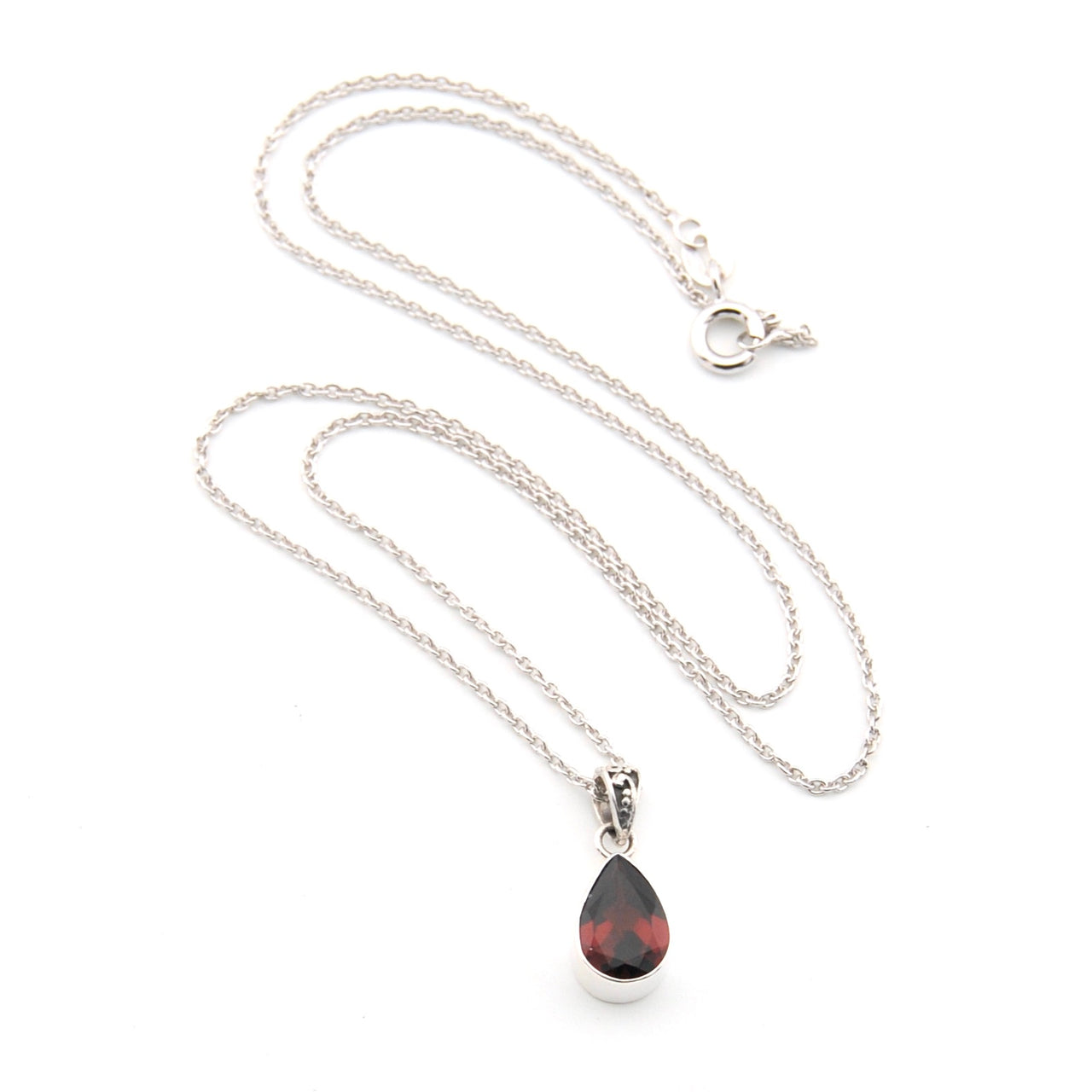 Silver necklace with a teardrop-shaped pendant on a white background