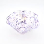 Clear glass bowl with purple speckles on a white background