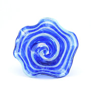 Blue and white glass bowl with swirling pattern on a white background