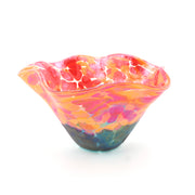 Colorful glass bowl with pink, orange, and blue swirls on a white background