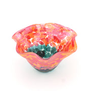 Glass bowl with pink and orange marbled design on a white background