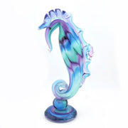 Colorful glass seahorse figurine on a white background