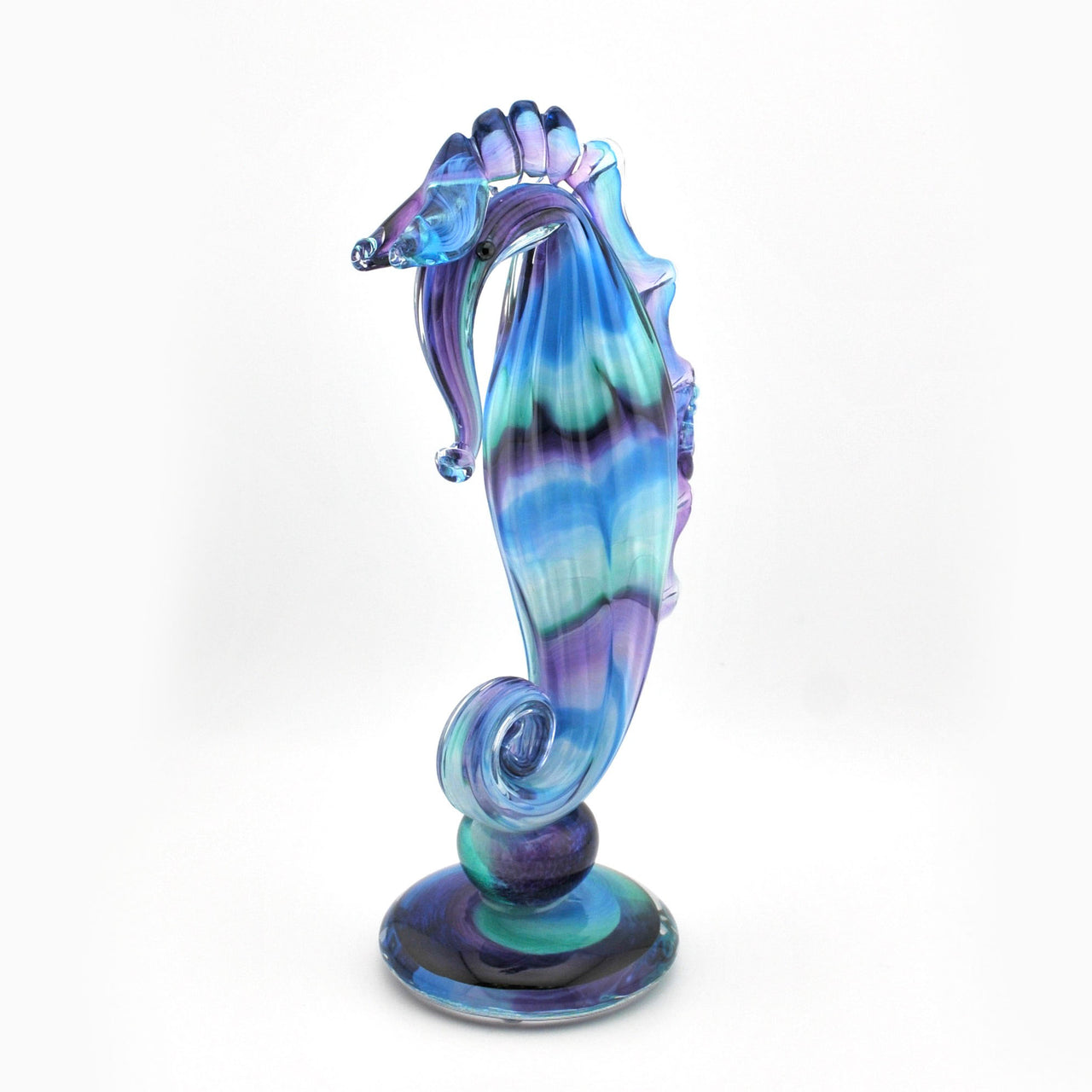 Colorful glass seahorse figurine on a white background