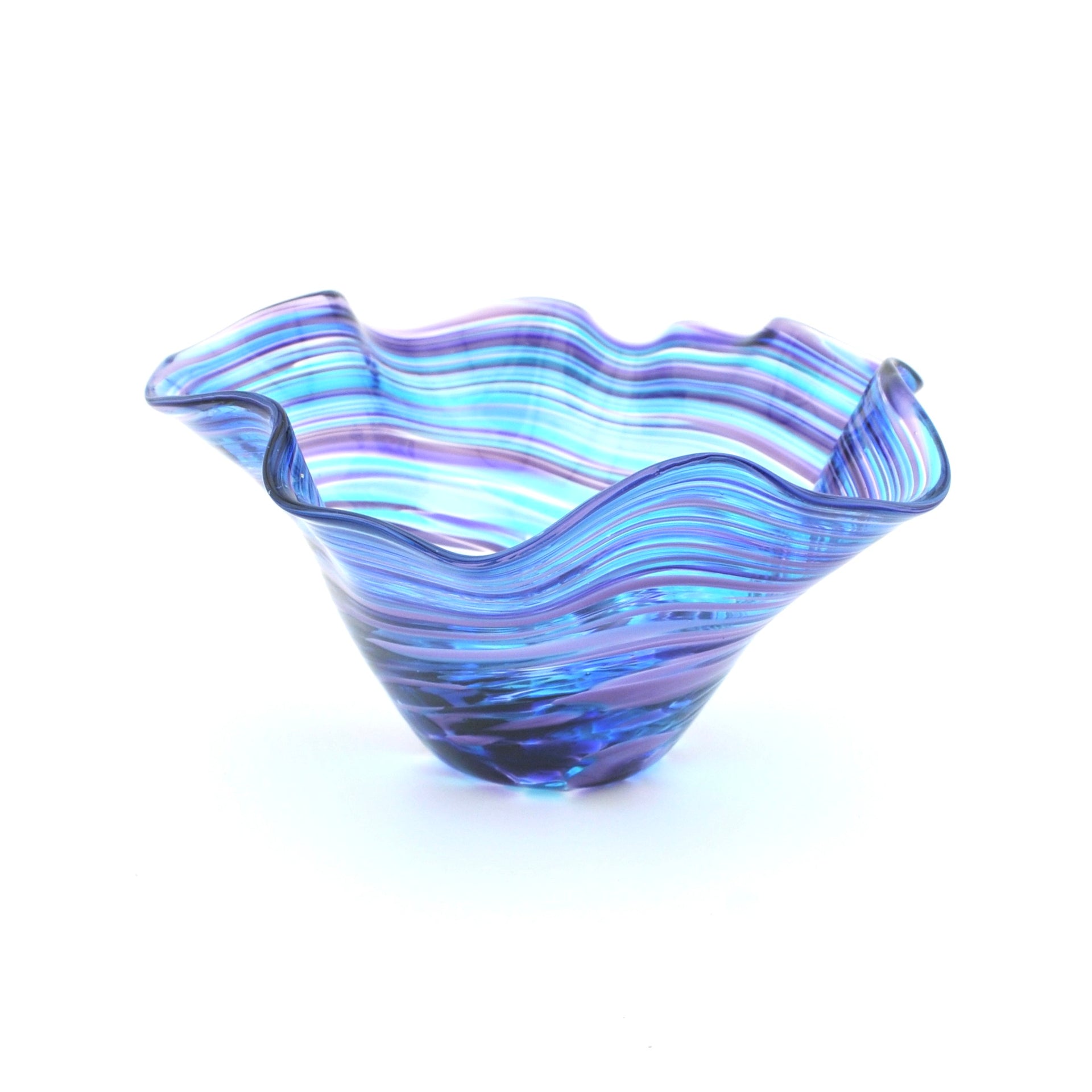 Blue glass bowl with wavy design on a white background
