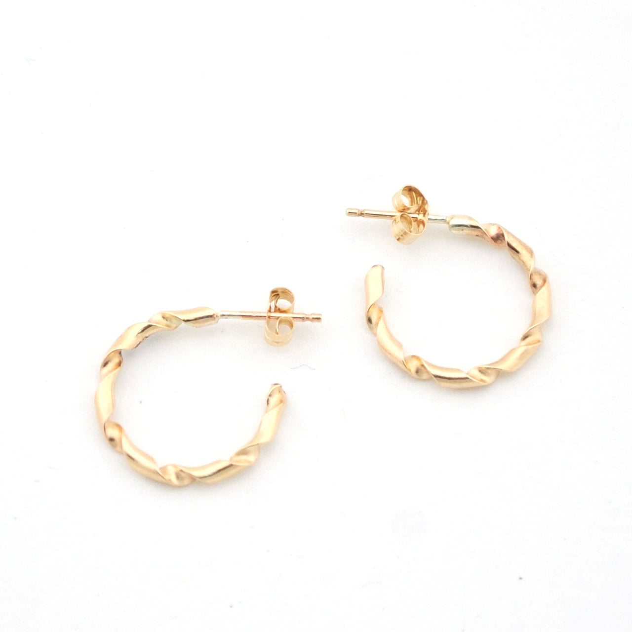 Gold hoop earrings on a white background