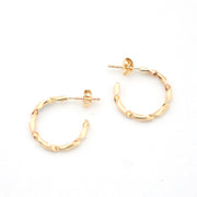 Gold hoop earrings on a white background