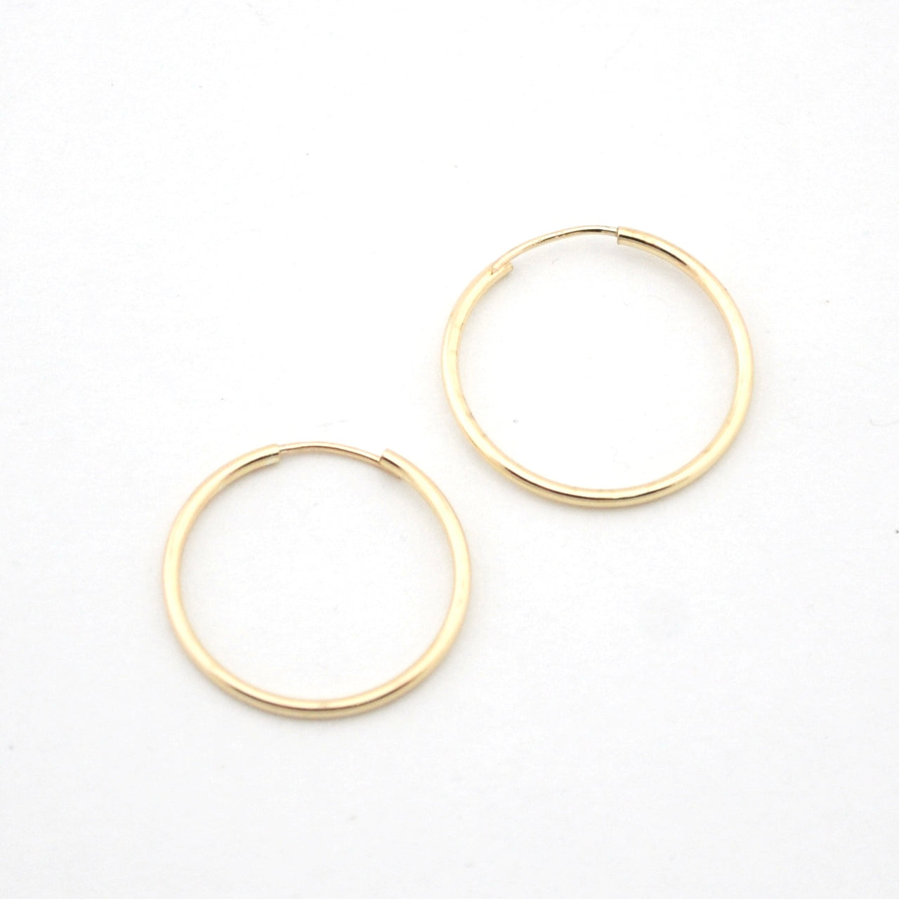 Gold hoop earrings on a white background
