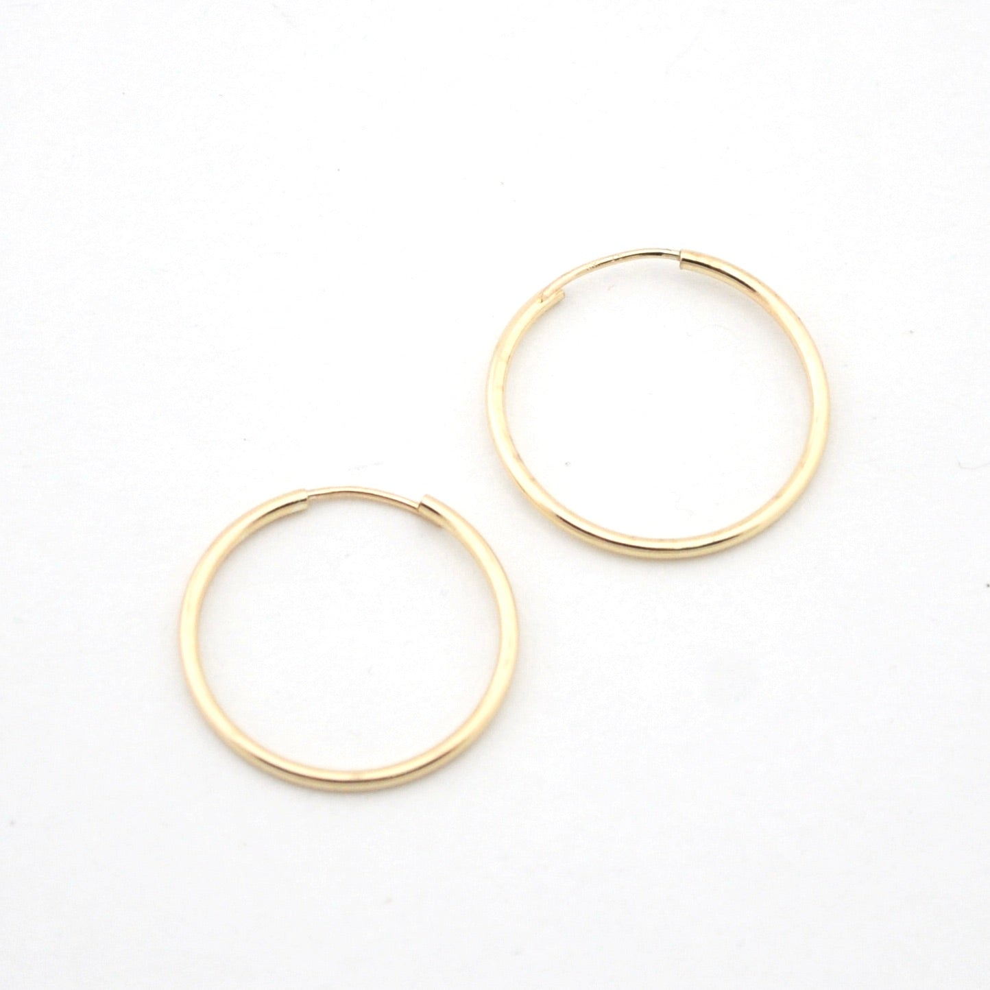Gold hoop earrings on a white background