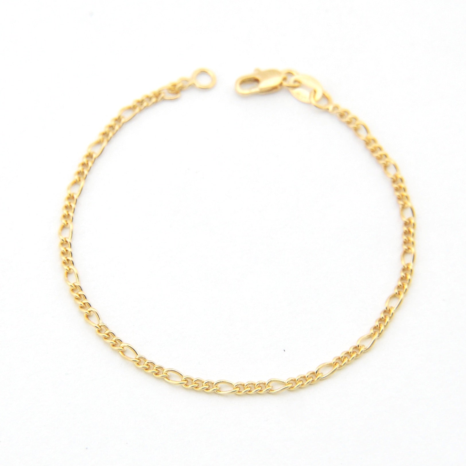 Gold chain bracelet on a white background
