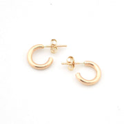 Gold hoop earrings on a white background