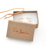 Gold necklace and earrings in a 'Be Jeweled' box on a white background