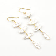Pearl earrings with gold hooks on a white background