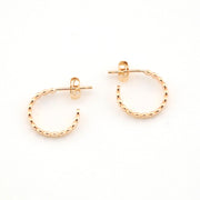 Gold hoop earrings on a white background