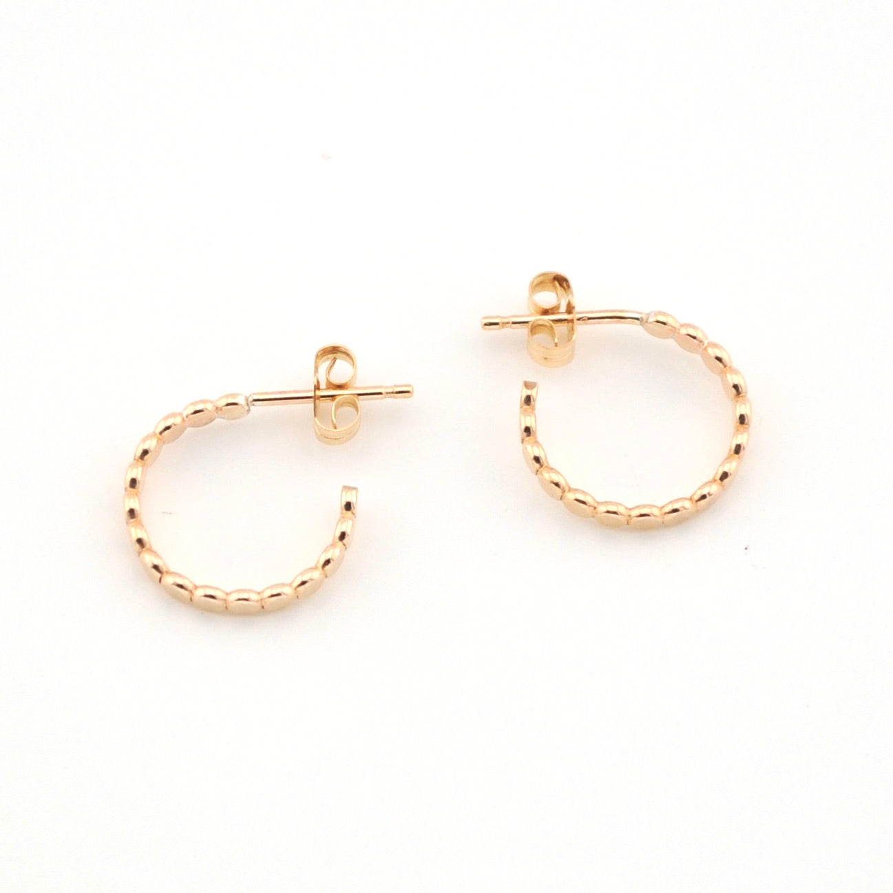 Gold hoop earrings on a white background