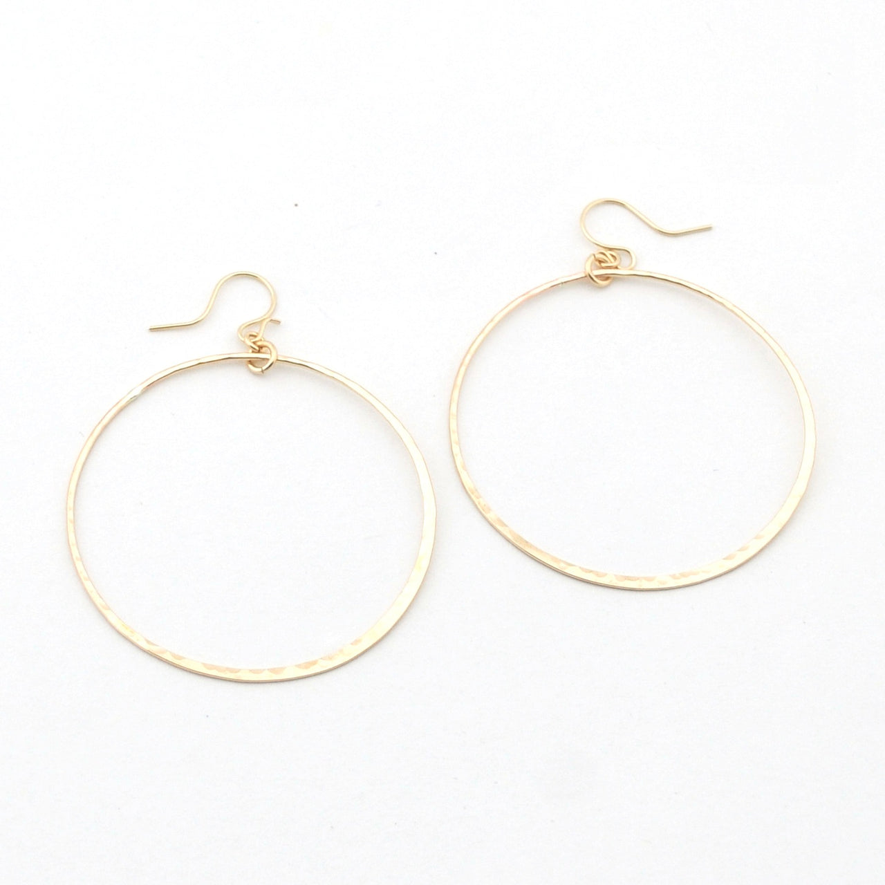Gold hoop earrings on a white background