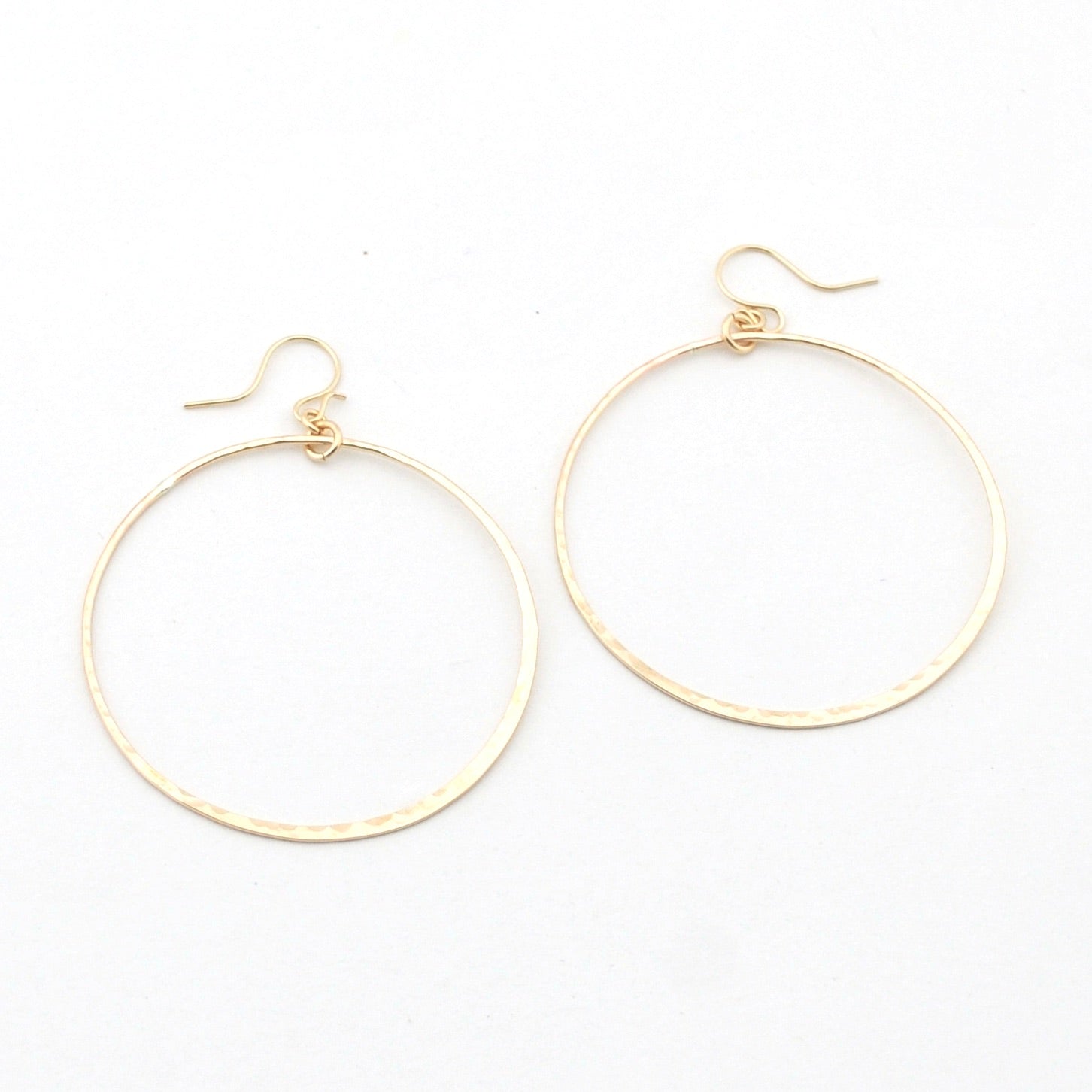 Gold hoop earrings on a white background
