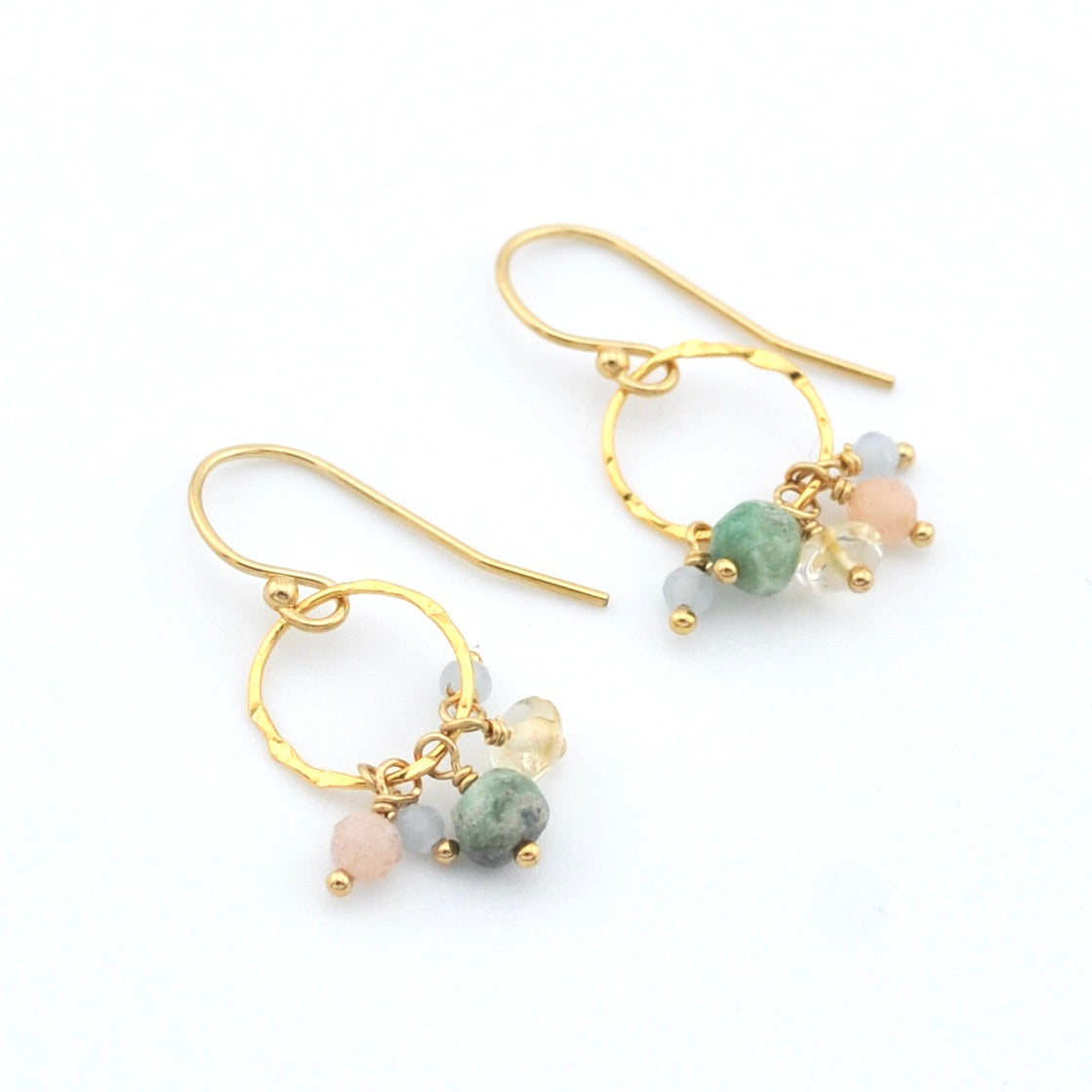 Gold hoop earrings with colorful beads on a white background