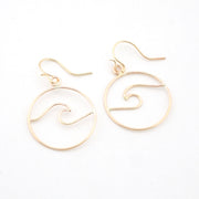 Gold wave-shaped earrings on a white background
