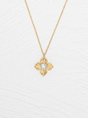Gold necklace with a floral pendant on a white background