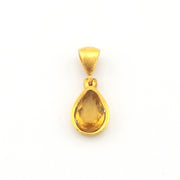 A gold pendant featuring a teardrop-shaped yellow gemstone, shown against a plain white background.