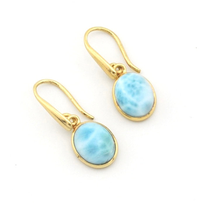 A pair of gold drop earrings with oval light blue marbled stone pendants, shown on a plain white background.